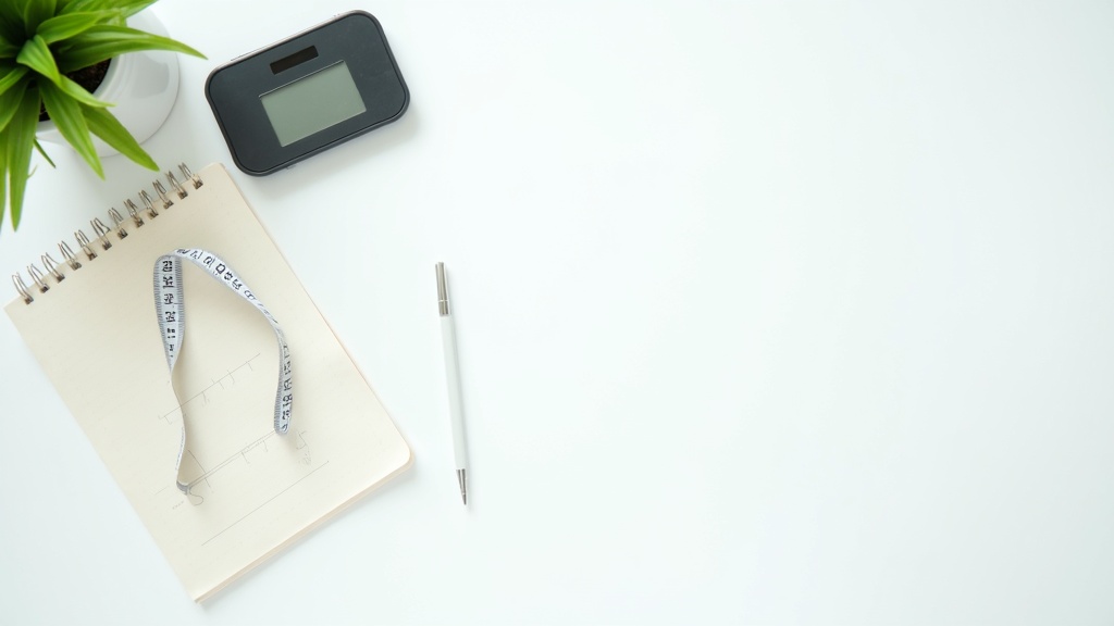 Digital scale and measuring tape beside a health chart notebook